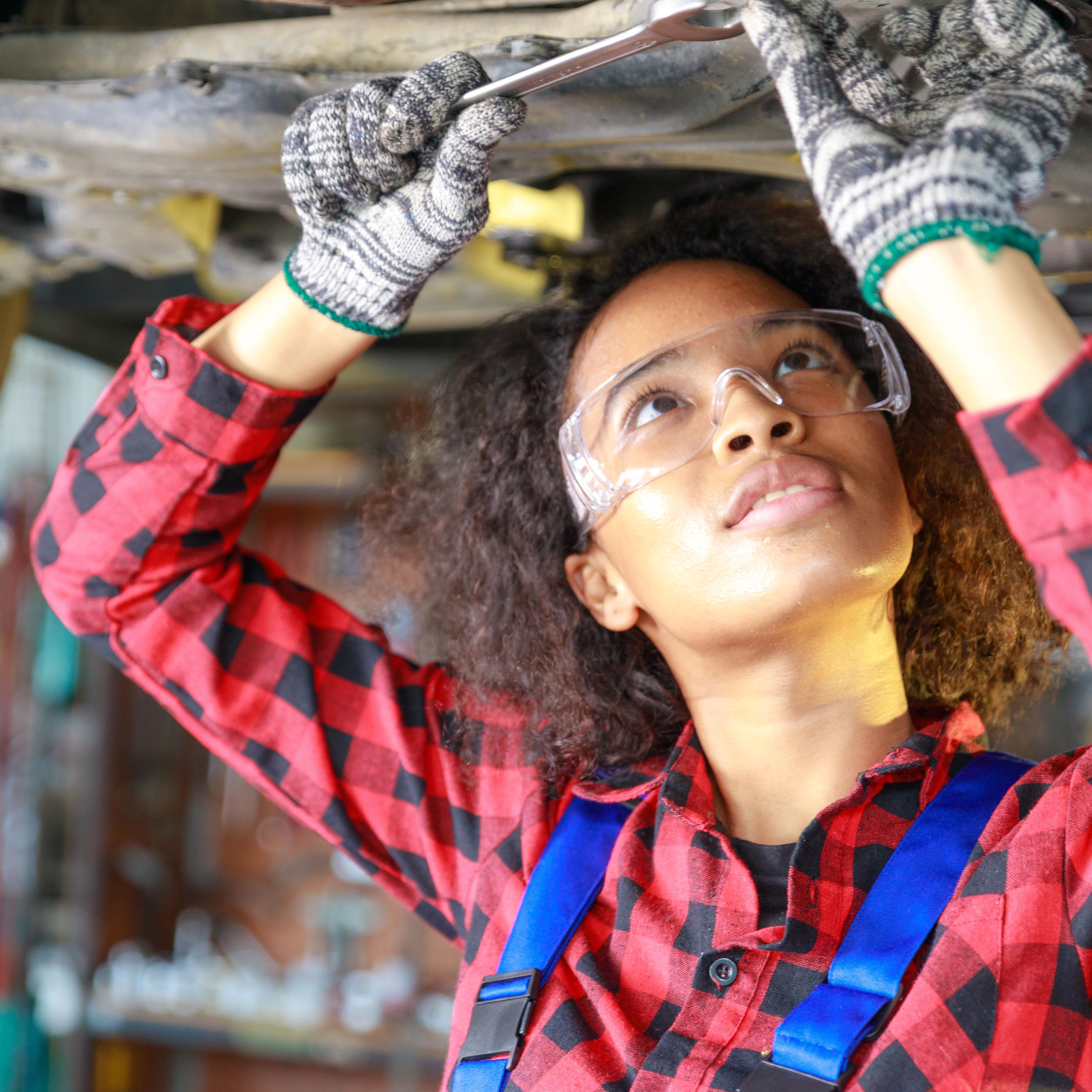 Woman Working on Car