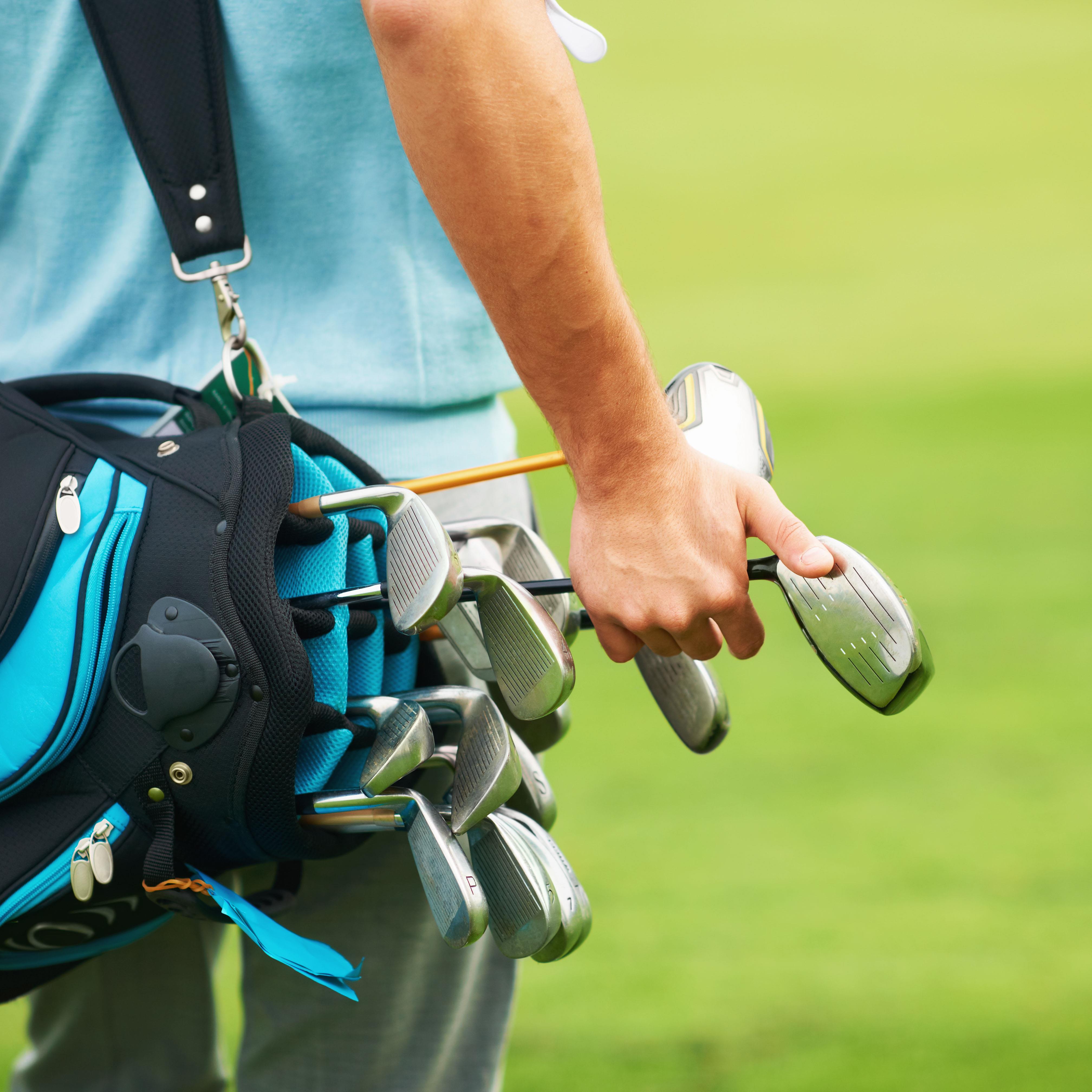 Person Holding Golf Clubs